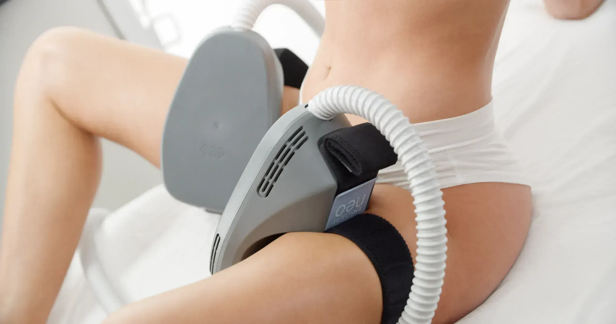 Adult patient evaluating Emsculpt Neo pain relief candidacy with Dr. Reznikov in Reisterstown