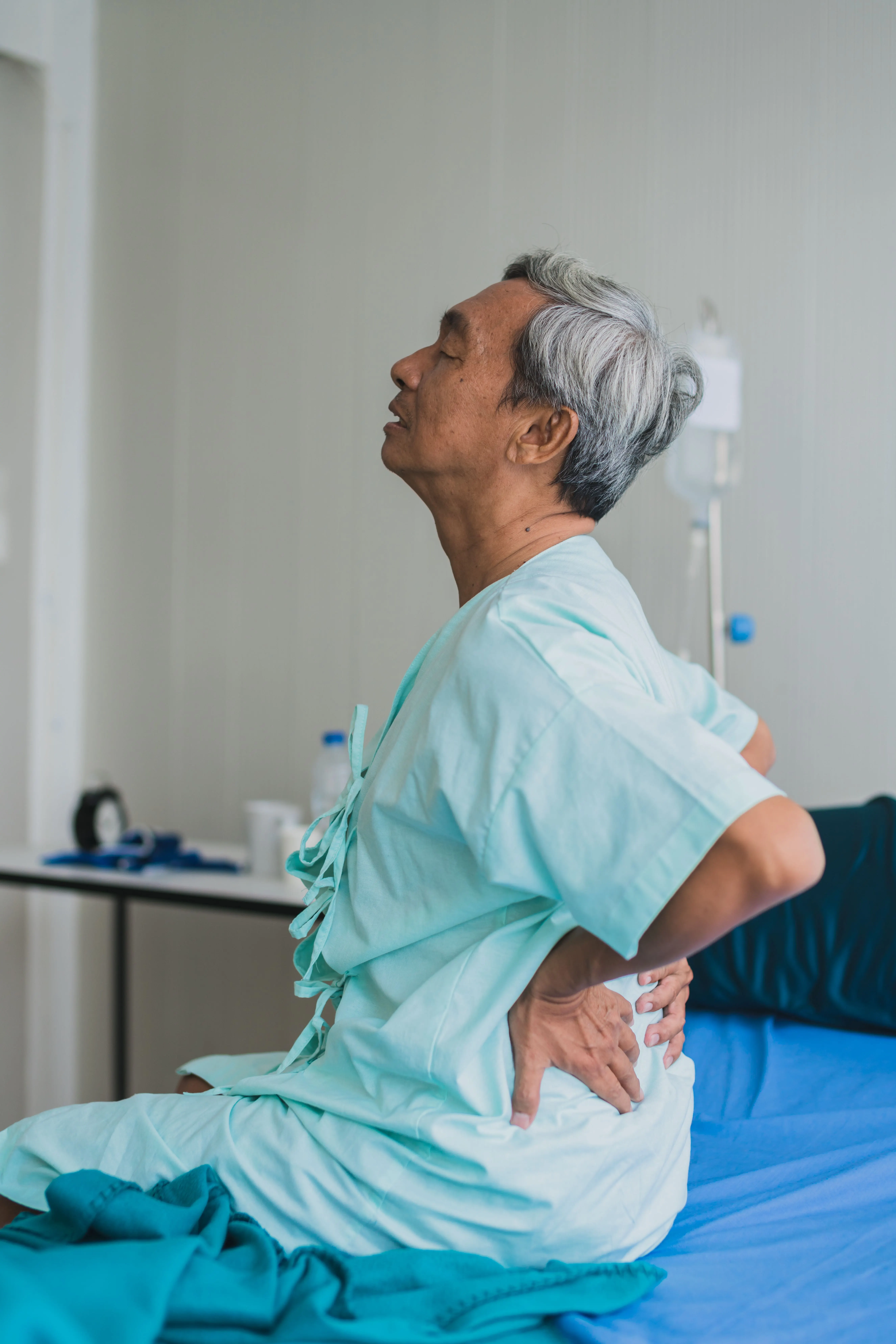 Person concerned about back and leg pain at Pain Treatment Center of Maryland